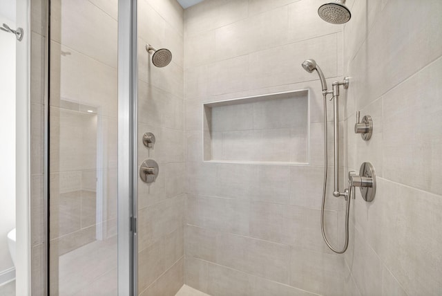 bathroom with a shower with door