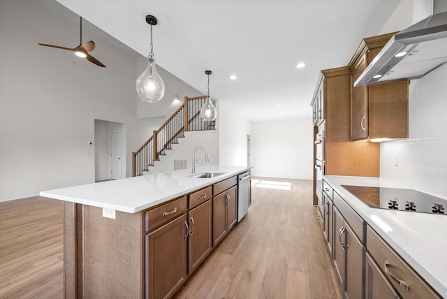 kitchen with dishwasher, sink, black electric stovetop, extractor fan, and a center island with sink