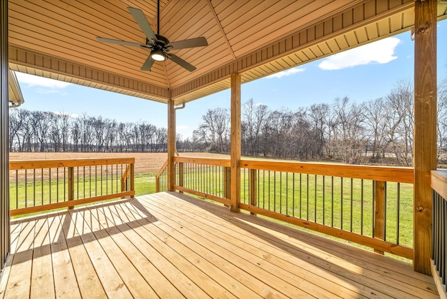 deck with a lawn and ceiling fan