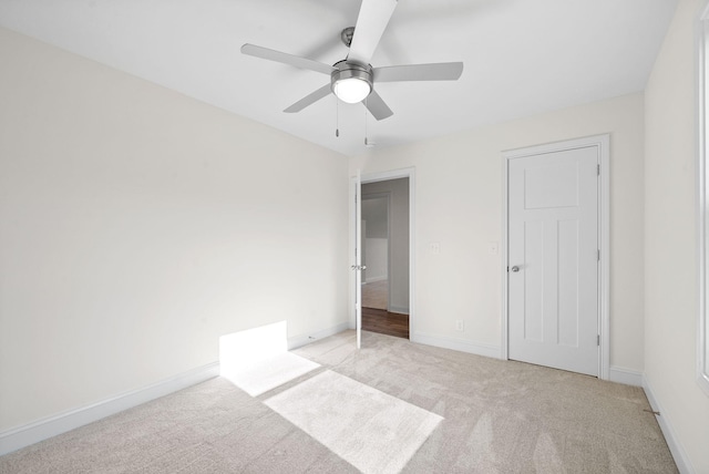 unfurnished bedroom with ceiling fan and light carpet