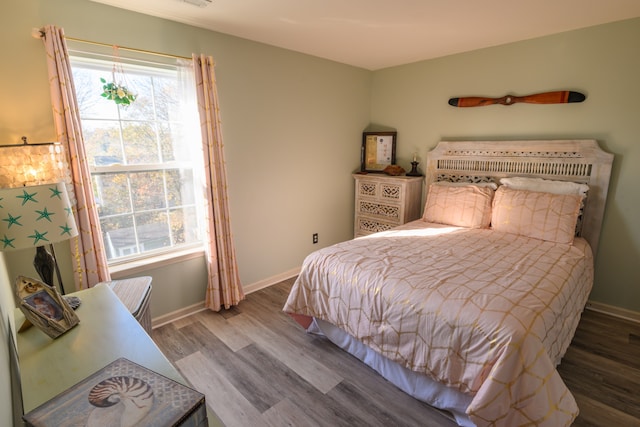 bedroom with hardwood / wood-style flooring