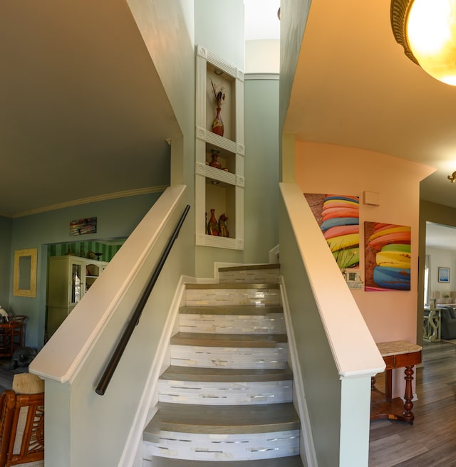 stairs featuring hardwood / wood-style floors