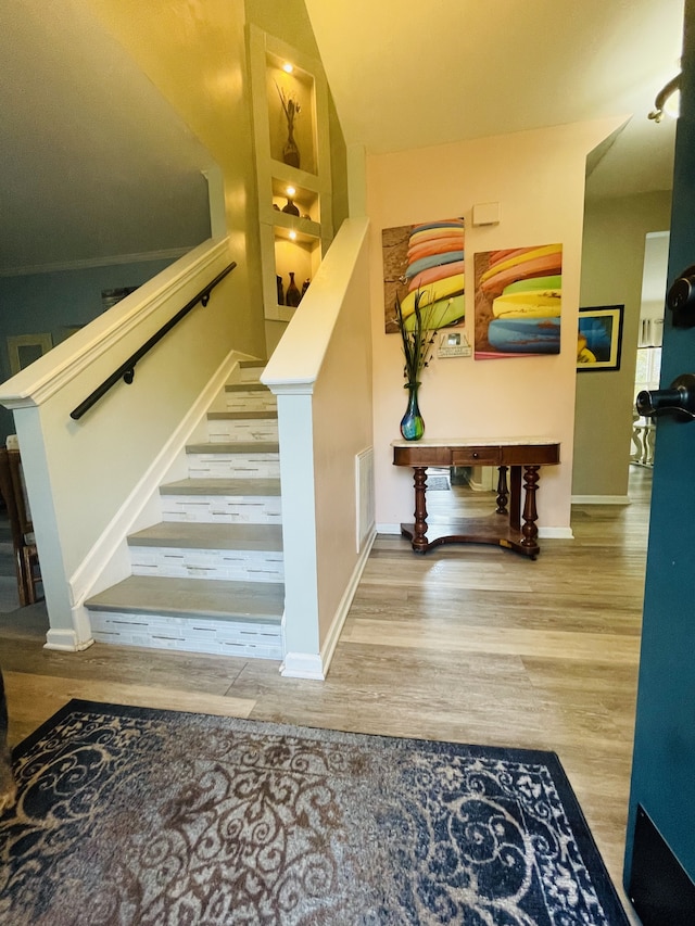 staircase with hardwood / wood-style floors