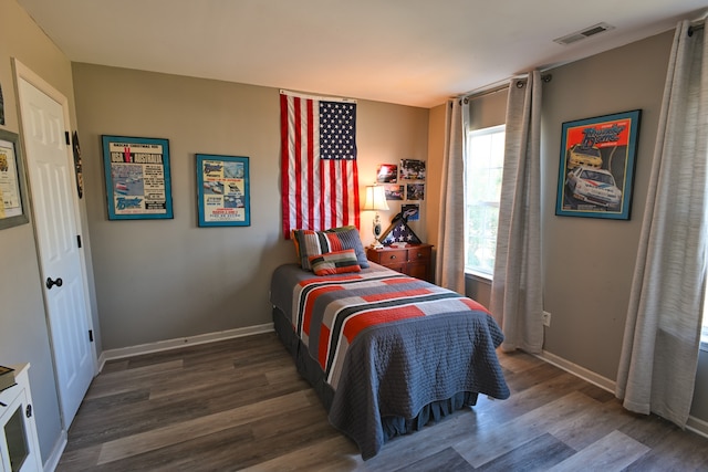 bedroom featuring dark wood-type flooring