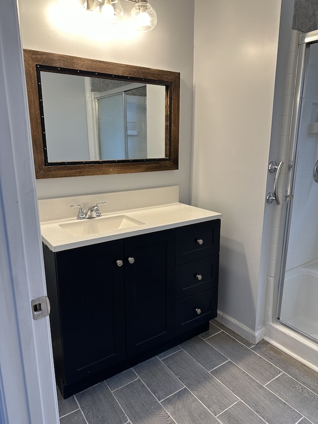 bathroom with vanity and a shower with shower door