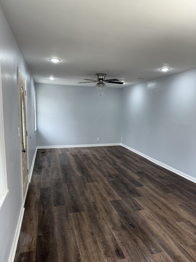 unfurnished room featuring dark hardwood / wood-style floors and ceiling fan