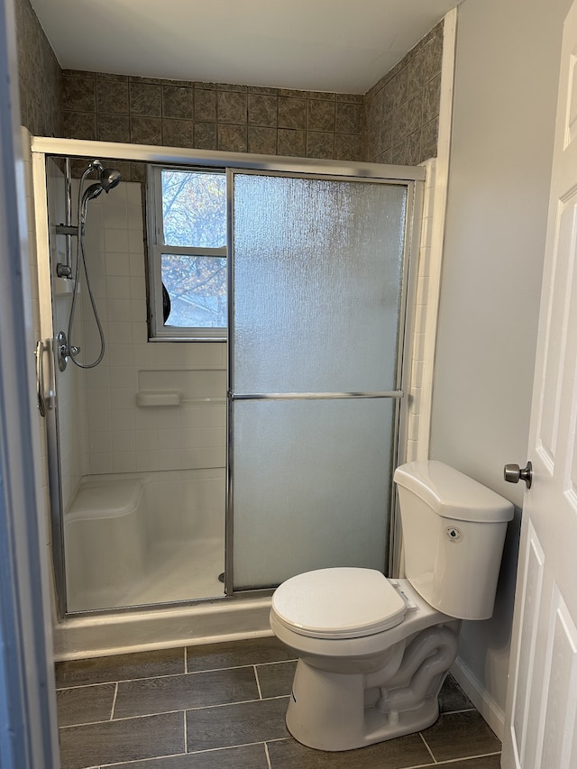 bathroom with toilet and walk in shower