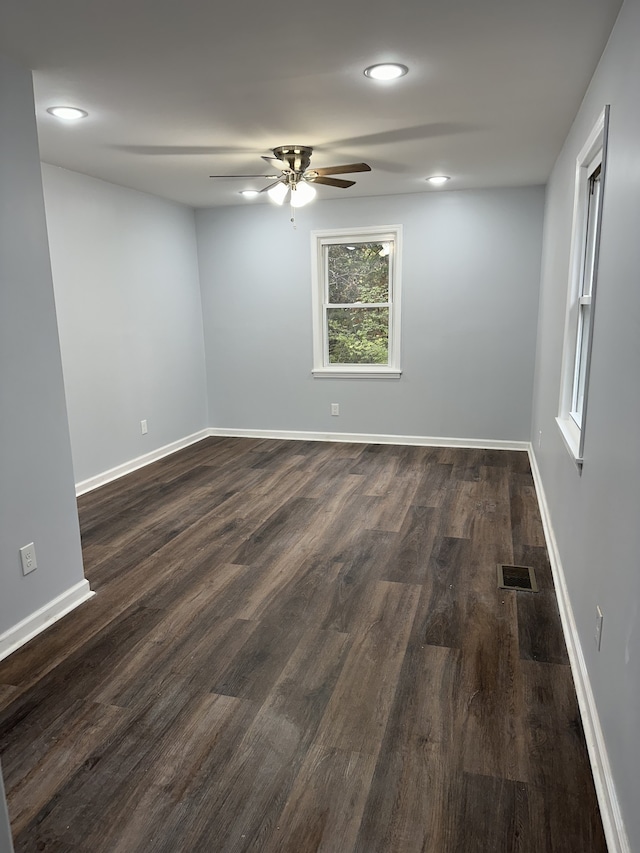 spare room with dark hardwood / wood-style floors and ceiling fan