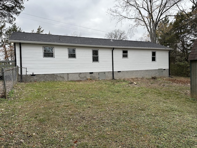 rear view of house with a yard