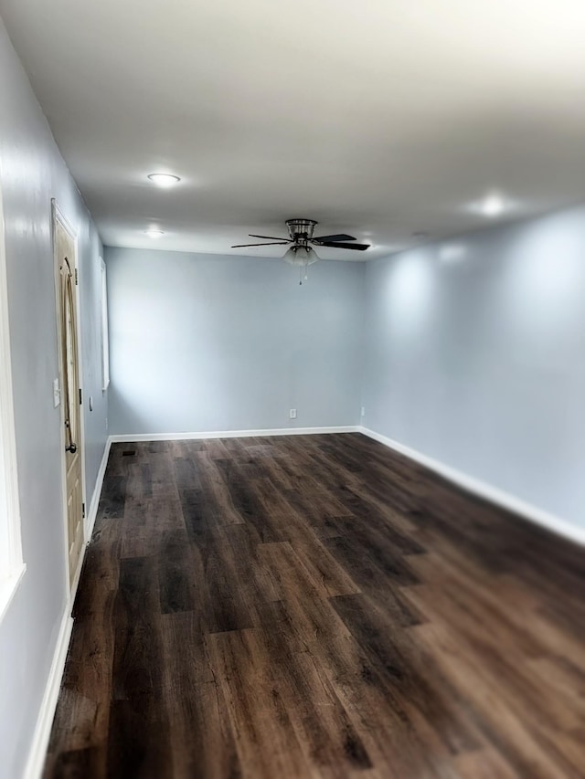 spare room featuring dark hardwood / wood-style flooring and ceiling fan