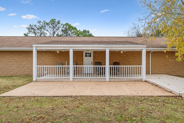 back of house featuring covered porch and ceiling fan