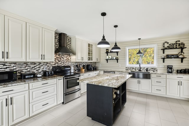 kitchen featuring light stone countertops, sink, wall chimney exhaust hood, stainless steel electric range, and a kitchen island