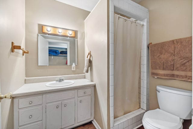 bathroom with vanity, curtained shower, and toilet