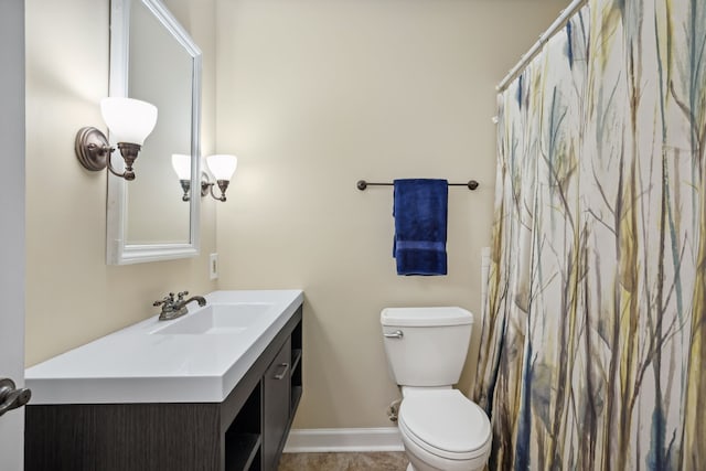 bathroom featuring tile patterned flooring, vanity, and toilet