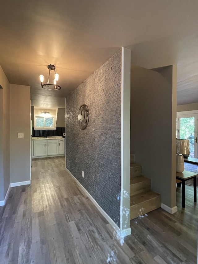 hall featuring a notable chandelier and dark hardwood / wood-style floors