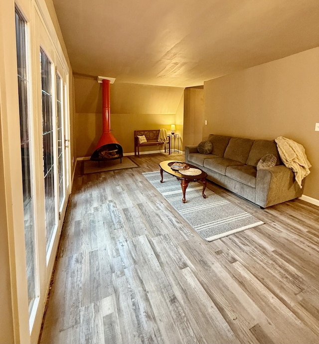 living room featuring light hardwood / wood-style floors and lofted ceiling