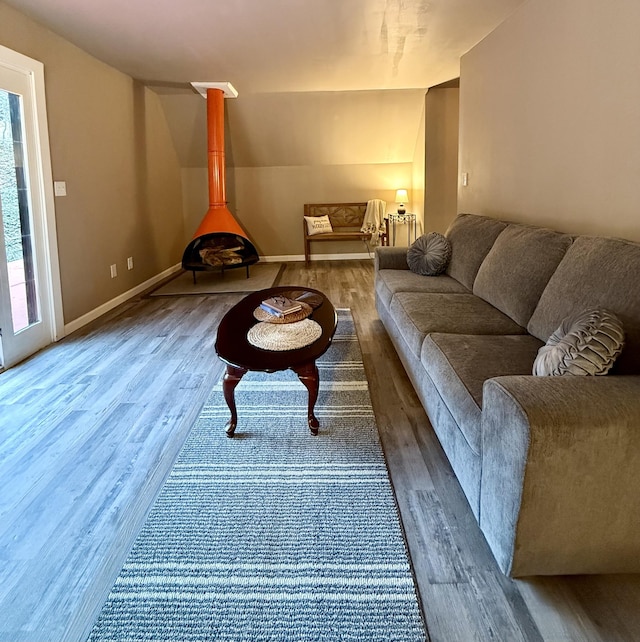 living room featuring wood-type flooring and vaulted ceiling