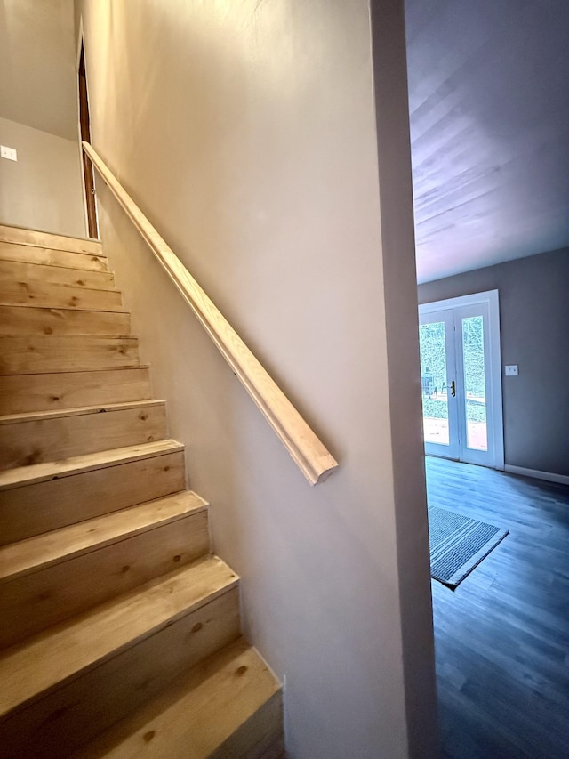 stairway featuring hardwood / wood-style floors and french doors