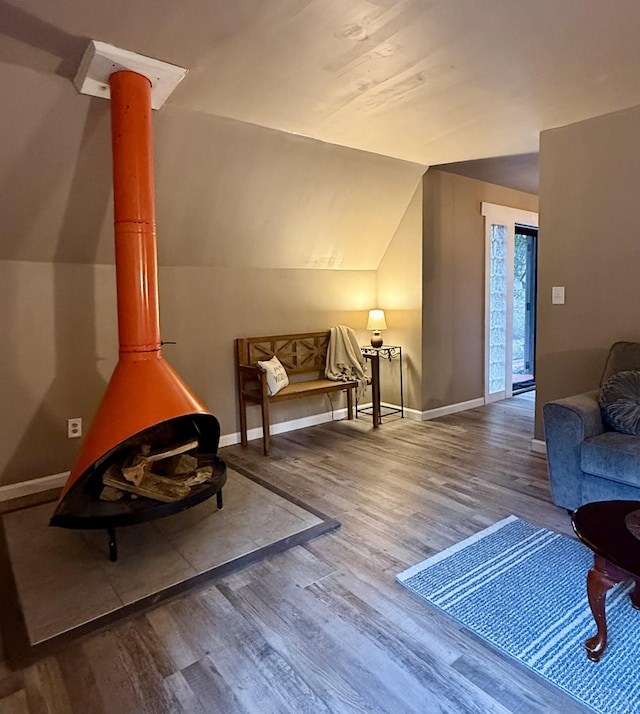 living room with hardwood / wood-style flooring and vaulted ceiling