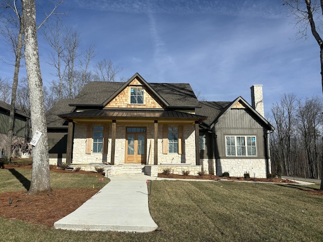 view of front of home with a front yard and covered porch