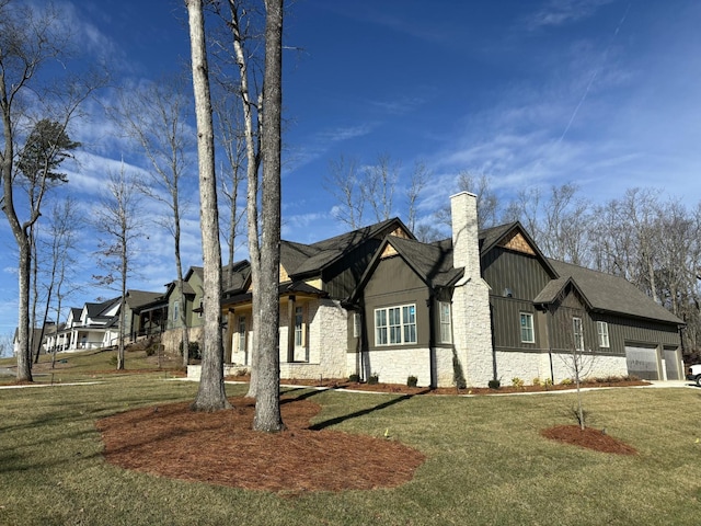 view of front of property featuring a garage and a front lawn