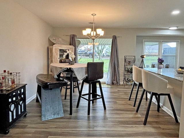 dining room featuring dark hardwood / wood-style floors and a chandelier