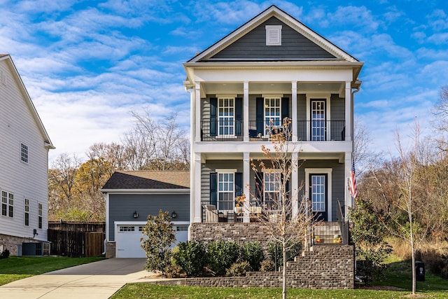 view of front of house with a porch, a garage, and central air condition unit