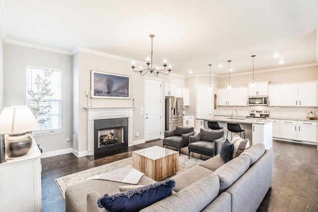 living room with crown molding, dark hardwood / wood-style flooring, and sink