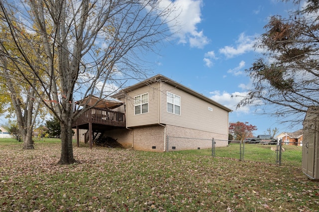 view of home's exterior with a yard and a wooden deck