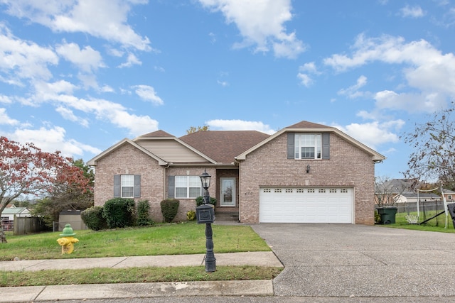 view of front of house with a garage and a front lawn