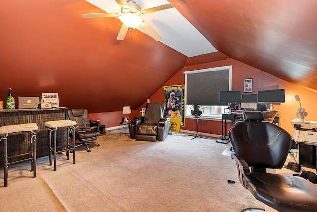 carpeted home office with ceiling fan and lofted ceiling