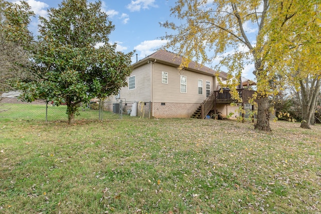 view of home's exterior featuring a yard and a wooden deck