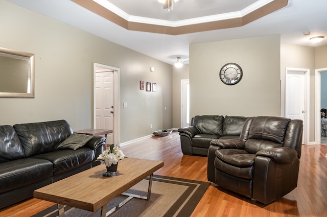 living room with hardwood / wood-style flooring, ceiling fan, and crown molding