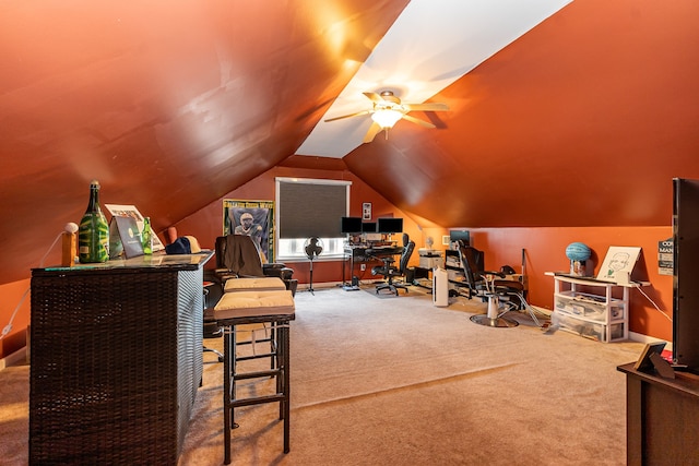 office area featuring ceiling fan, carpet floors, and lofted ceiling