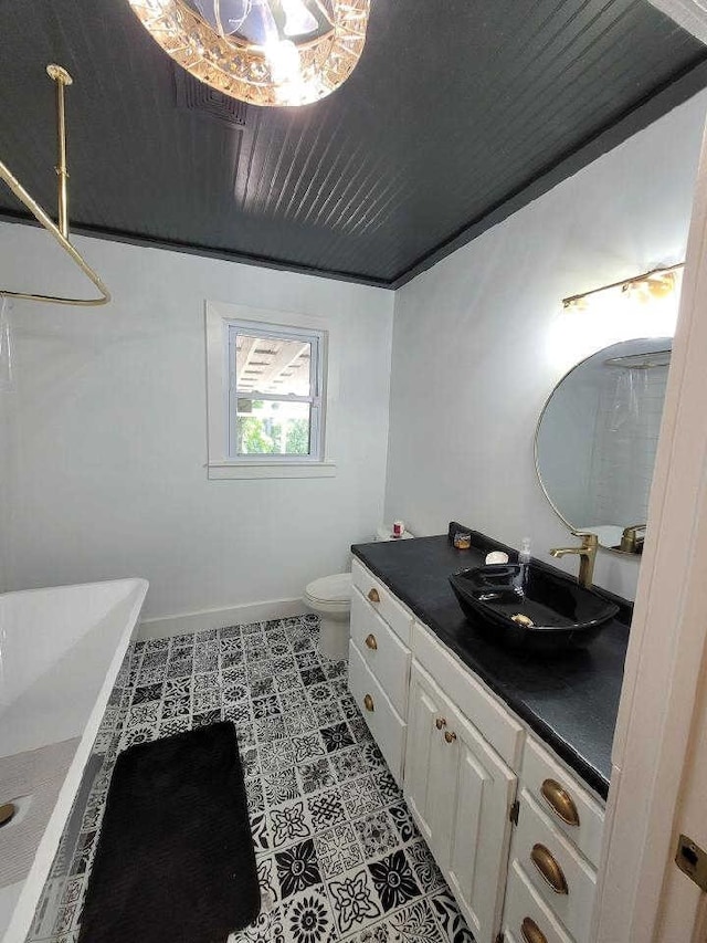 bathroom with tile patterned floors, vanity, and toilet