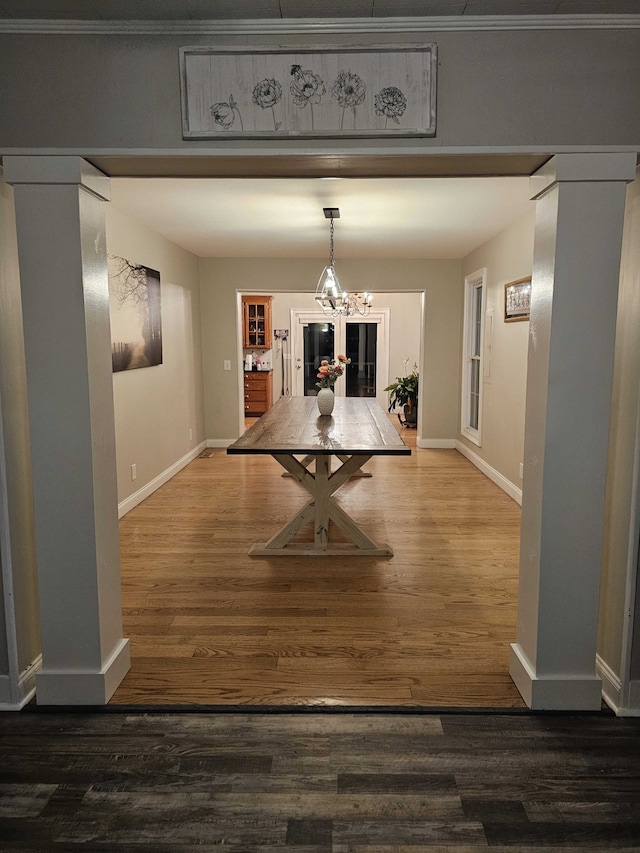 hall with a chandelier, dark hardwood / wood-style floors, and ornamental molding