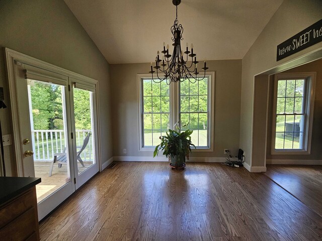 interior space with a chandelier, dark hardwood / wood-style flooring, a healthy amount of sunlight, and lofted ceiling