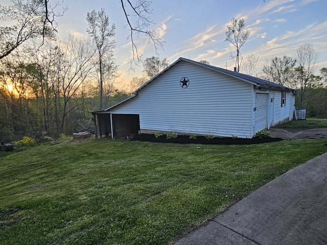 property exterior at dusk featuring a lawn