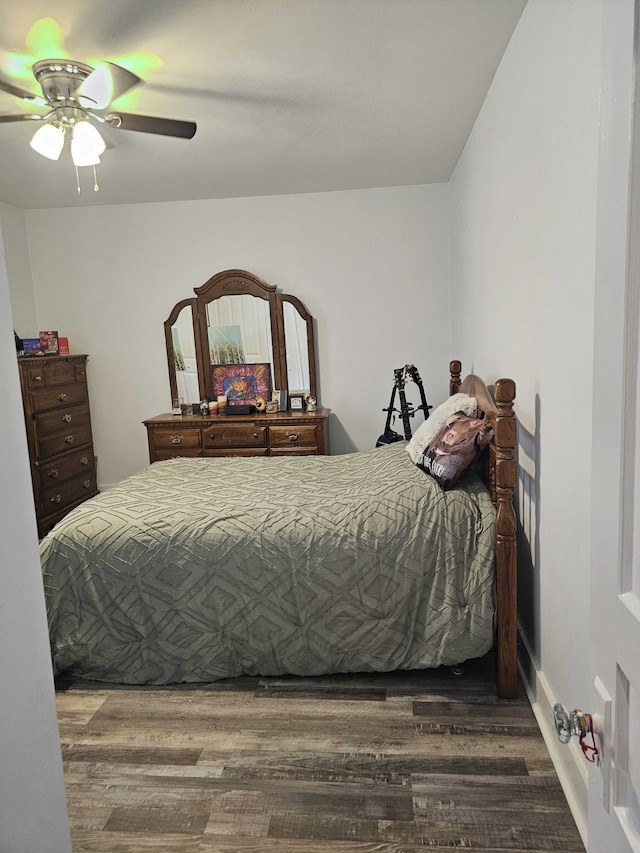 bedroom featuring ceiling fan and dark wood-type flooring