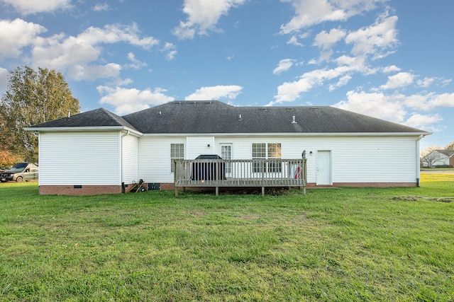 back of property with a lawn and a wooden deck