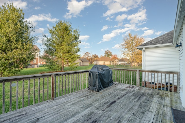 wooden deck with a yard and area for grilling