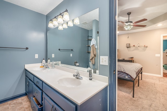 bathroom with tile patterned flooring, vanity, and ceiling fan