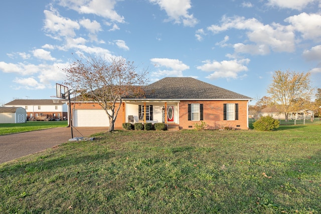 single story home with covered porch, a garage, and a front lawn