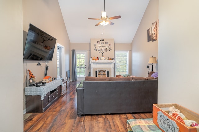 living room with dark hardwood / wood-style flooring, high vaulted ceiling, and ceiling fan