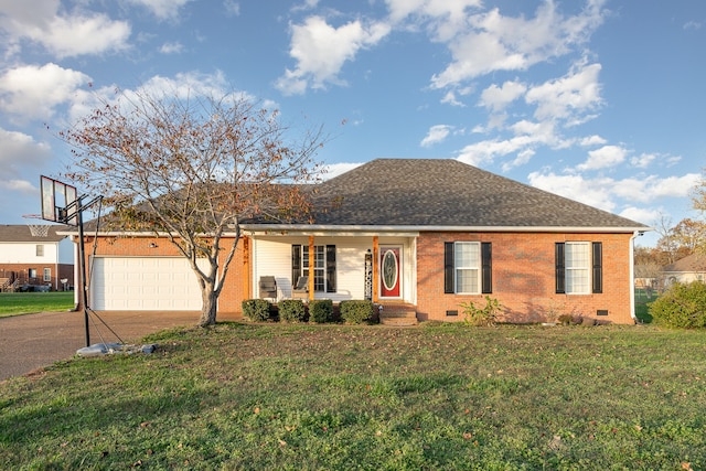 ranch-style home featuring covered porch, a front yard, and a garage