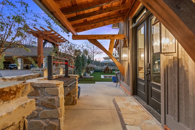 patio terrace at dusk with a pergola