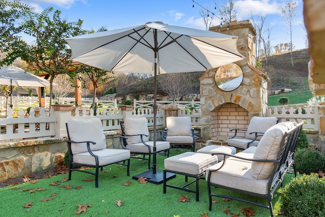 view of patio / terrace featuring an outdoor stone fireplace