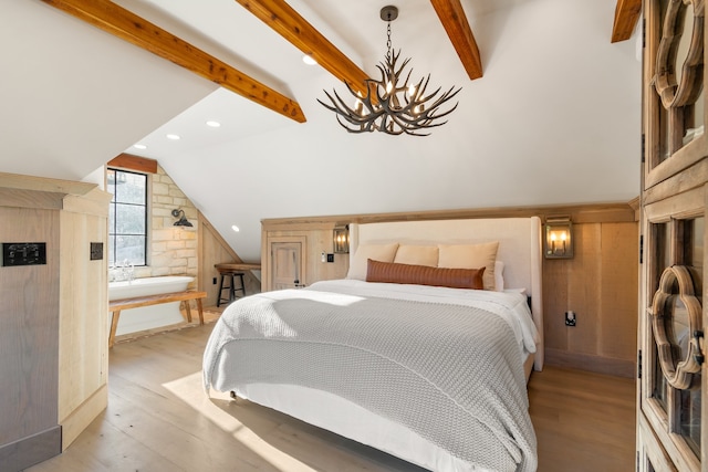 bedroom with lofted ceiling with beams, light wood-type flooring, and a chandelier