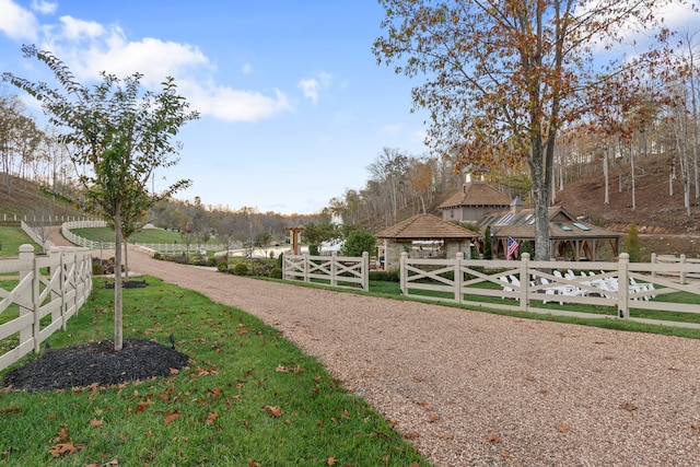 surrounding community with a rural view and a yard