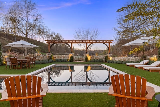 pool at dusk with a yard